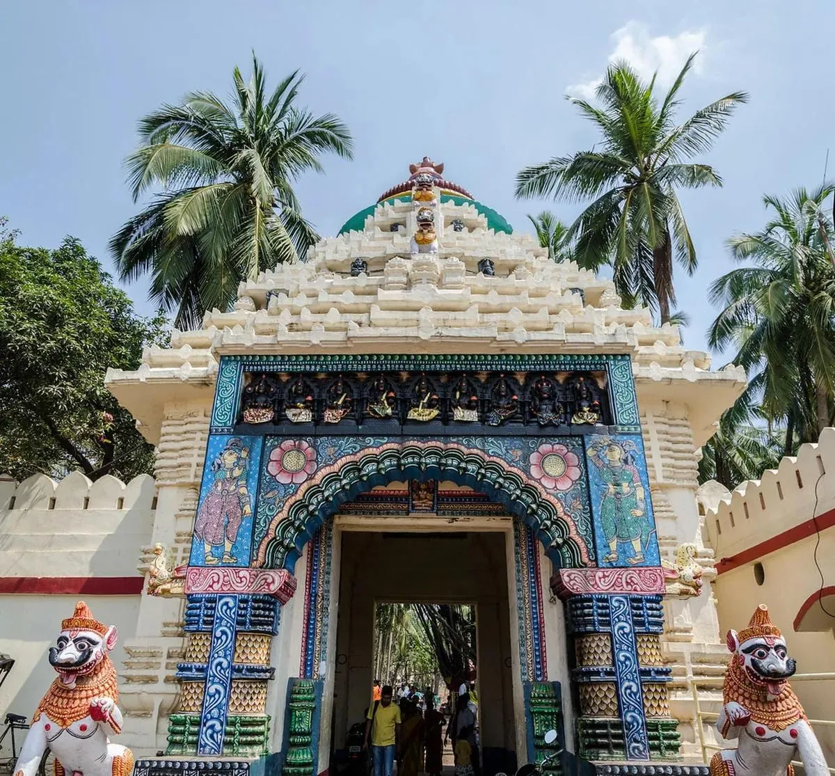 The temple’s decorated western gate, flanked by guardian statues