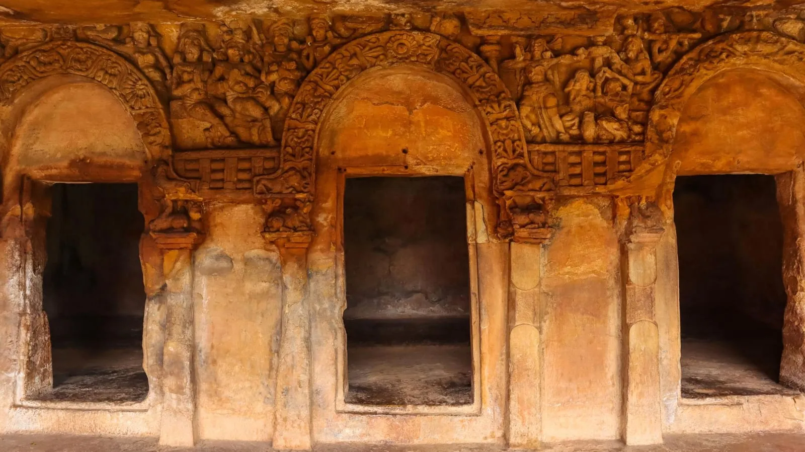 Carved cell doorways with decorative figural panels